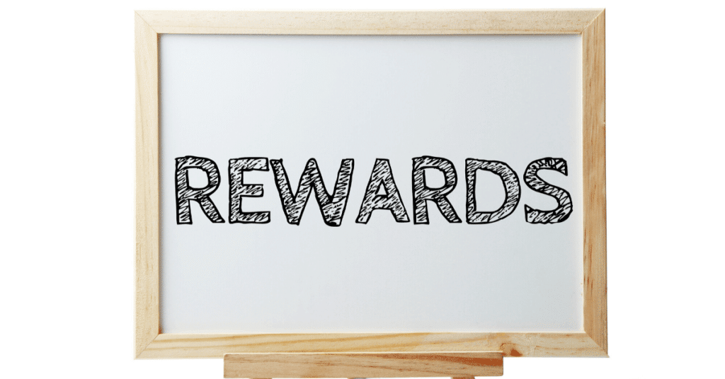 Whiteboard with the word "rewards" written on it