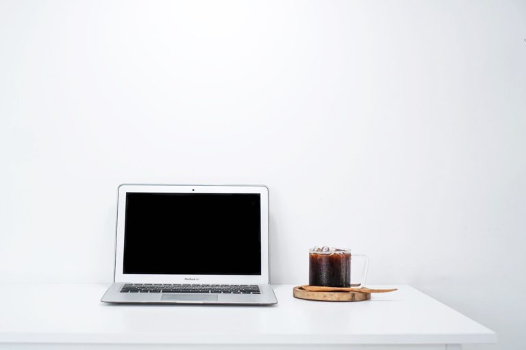 a laptop and an iced drink