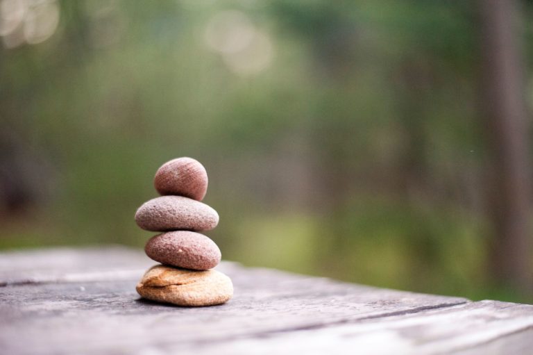 four pebbles perfectly stacked on each other