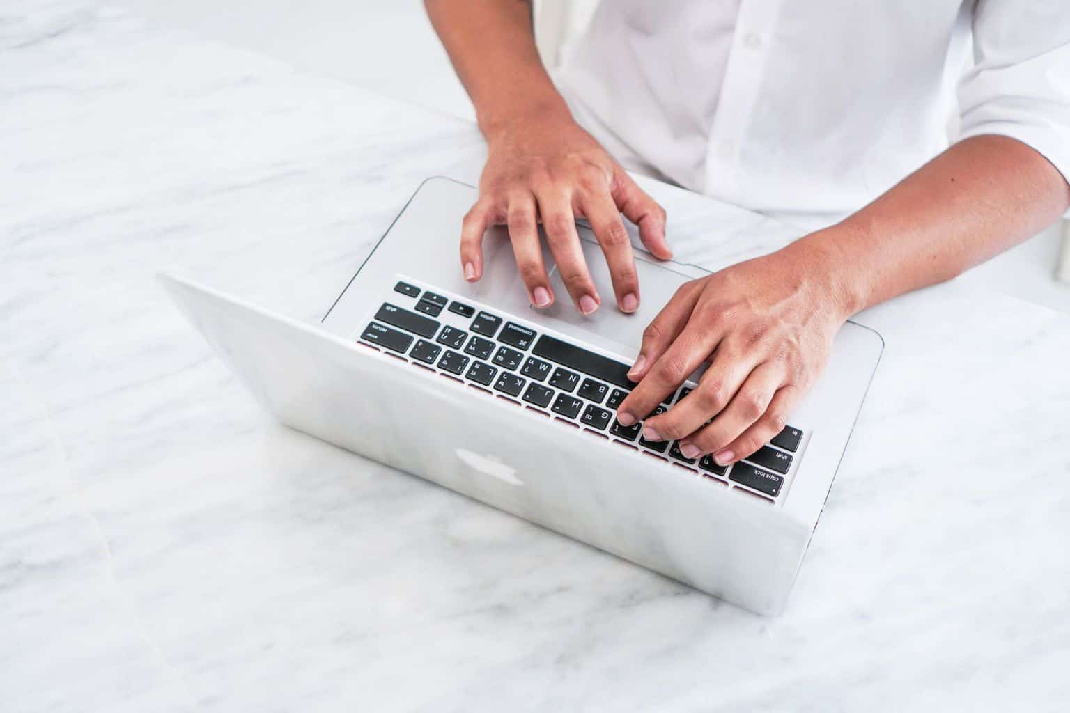 hand typing on laptop