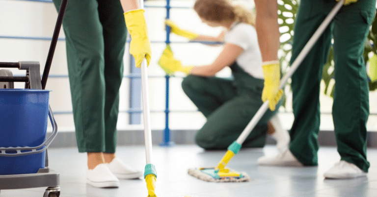 three people mopping an area