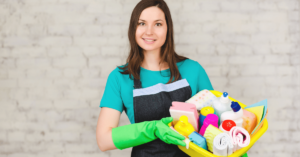 Understanding how to hire cleaners will net you A-players like this female cleaner holding a cleaning caddie