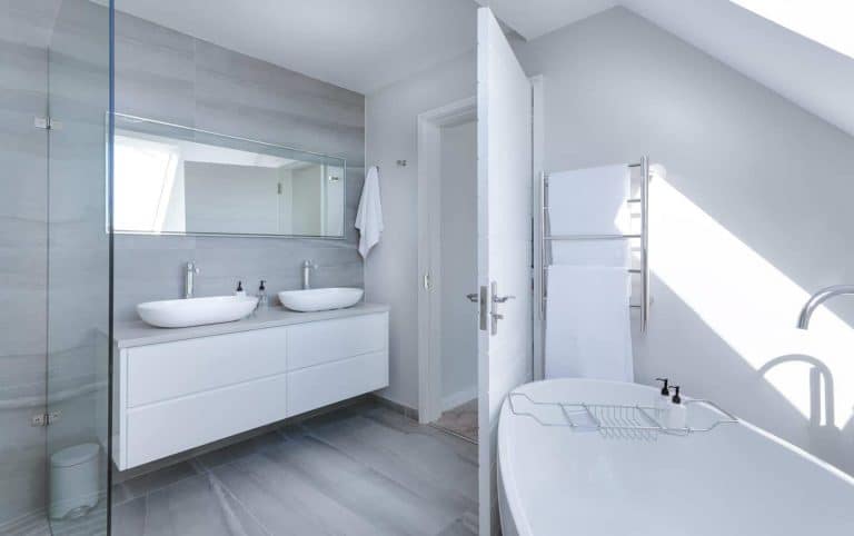 Knowing how to build a luxury cleaning business means you'll acquire elite clients, like this house with a grey and white modern bathroom