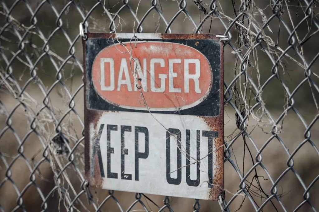 Danger Keep Out sign on chain link fence