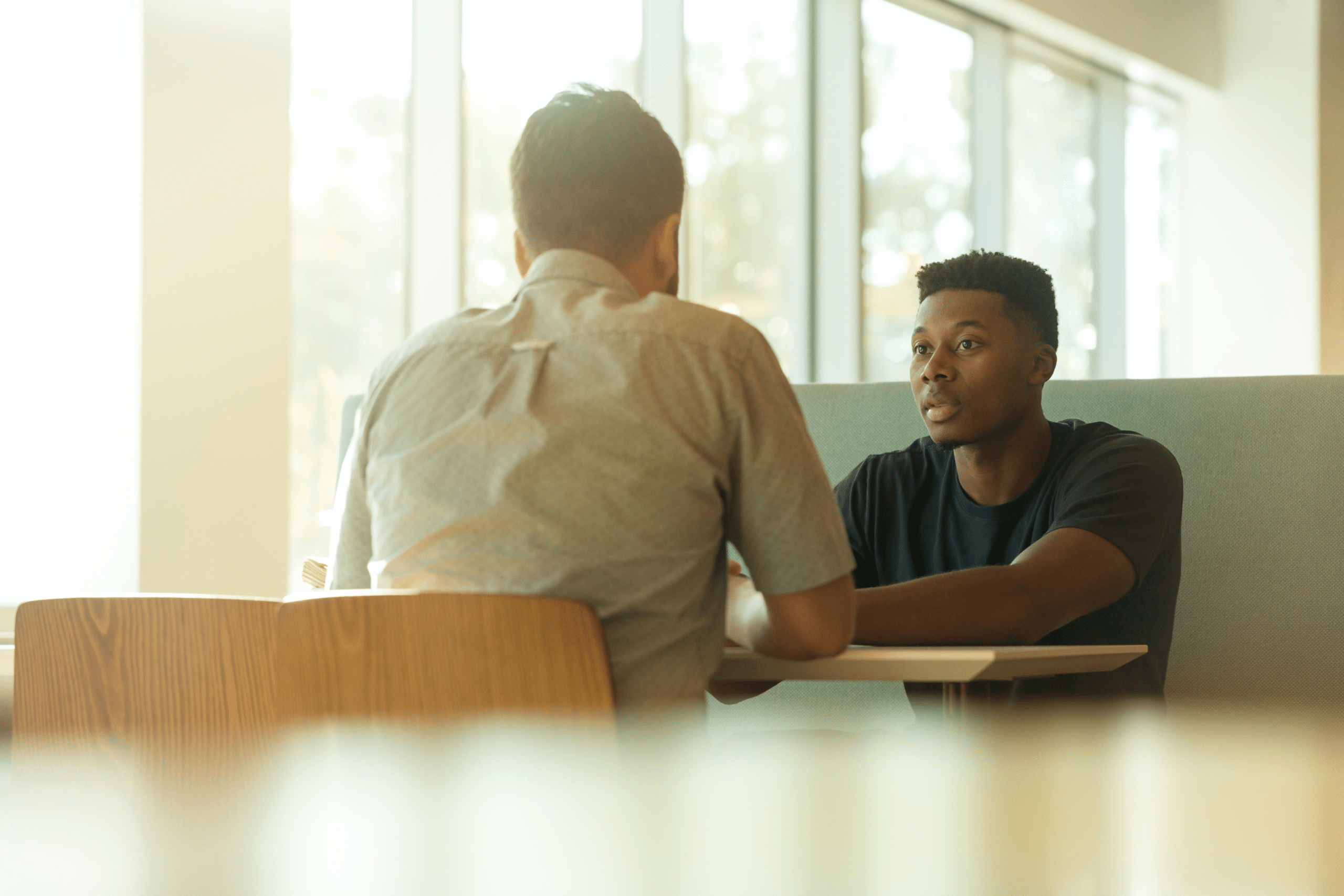 Two men talking seriously across a table