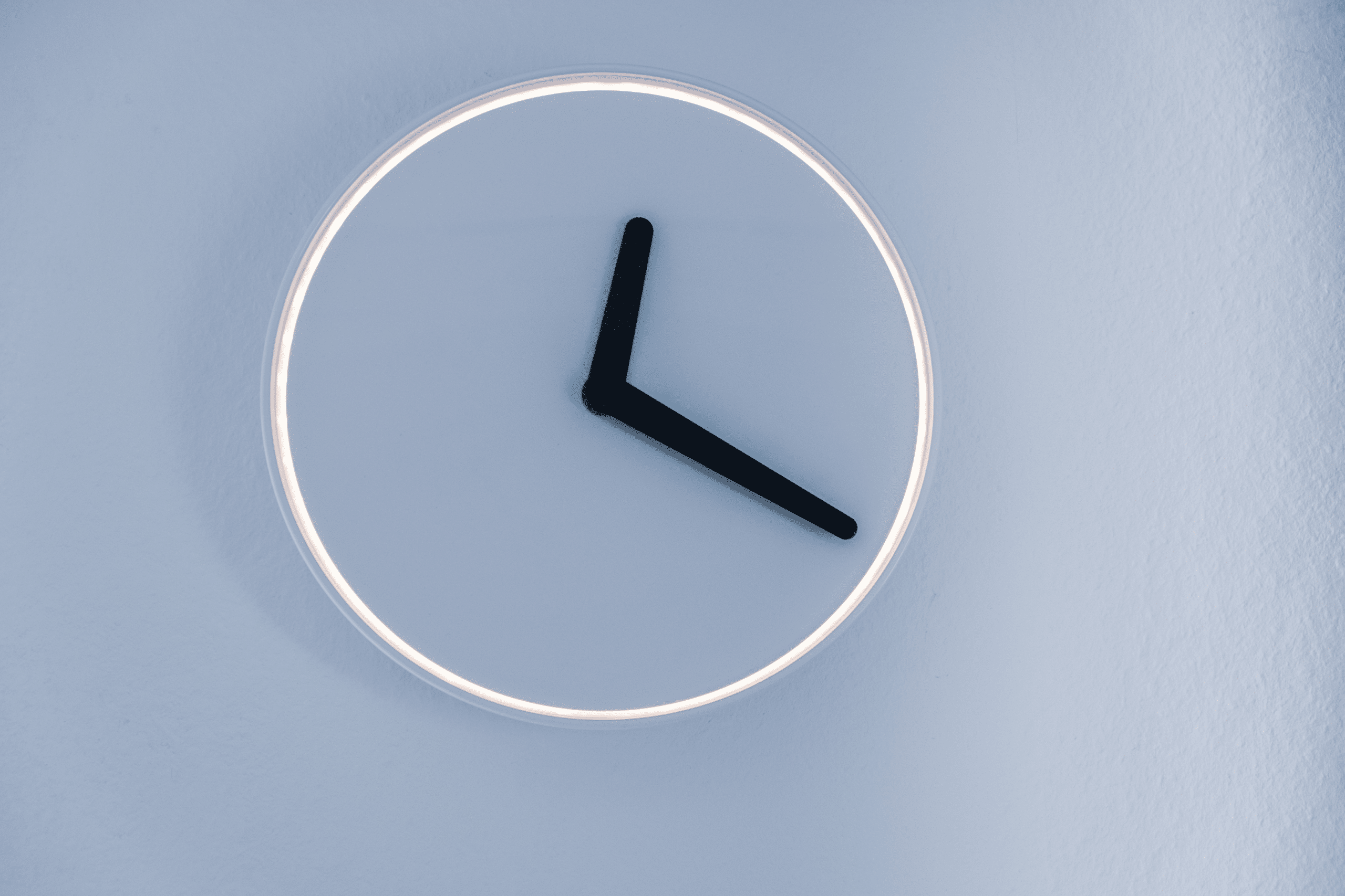 Minimalist clock hung on white wall